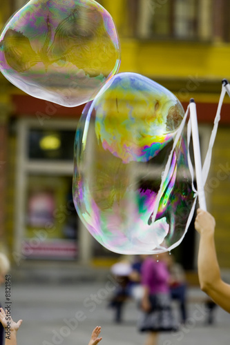 Blowing giant bubbles (street photo)..