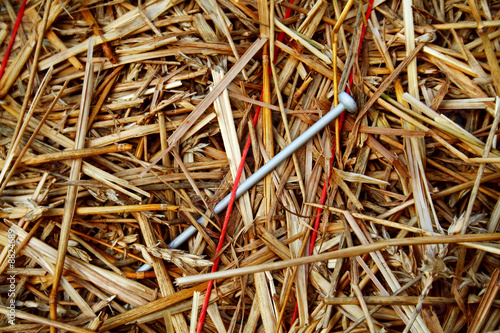 A needle stuck in a haystack bound in the twine photo