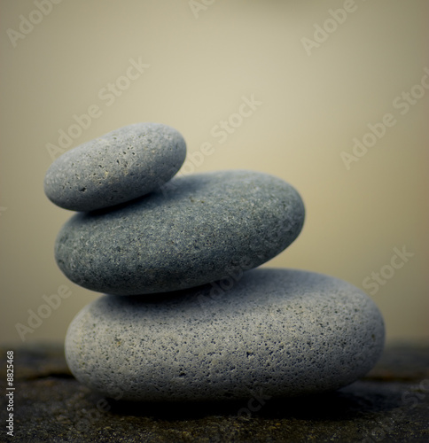 pebbles pyramid on a rock - zen background