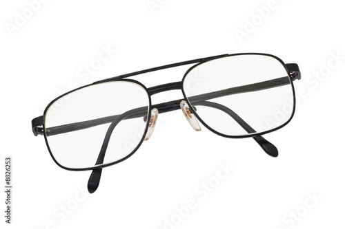 Old fashion metal frame spectacles on white background