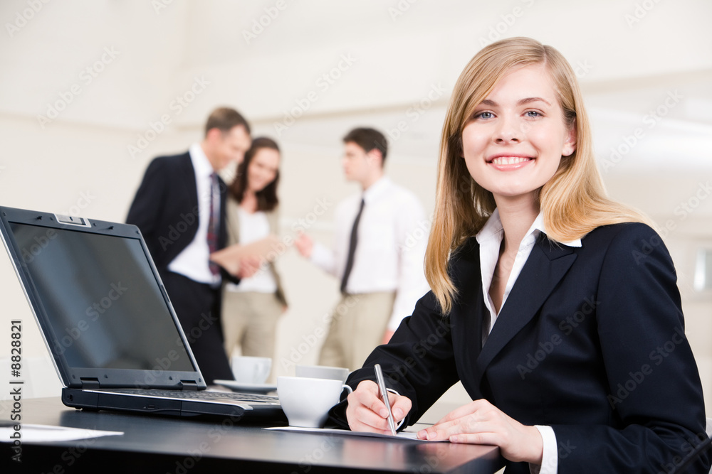 Portrait of confident businesswoman sitting at workplace Portrait of confident businesswoman sitting at workplace