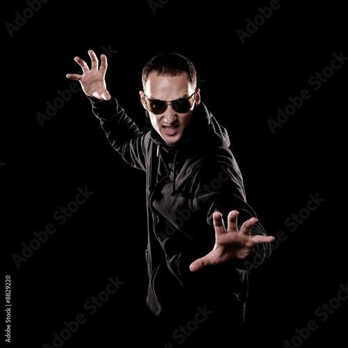 aggressive man with bared teeth over black background