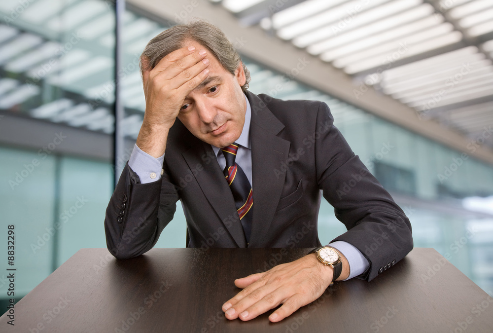 mature business man on a desk at the office mature business man on a desk at the office