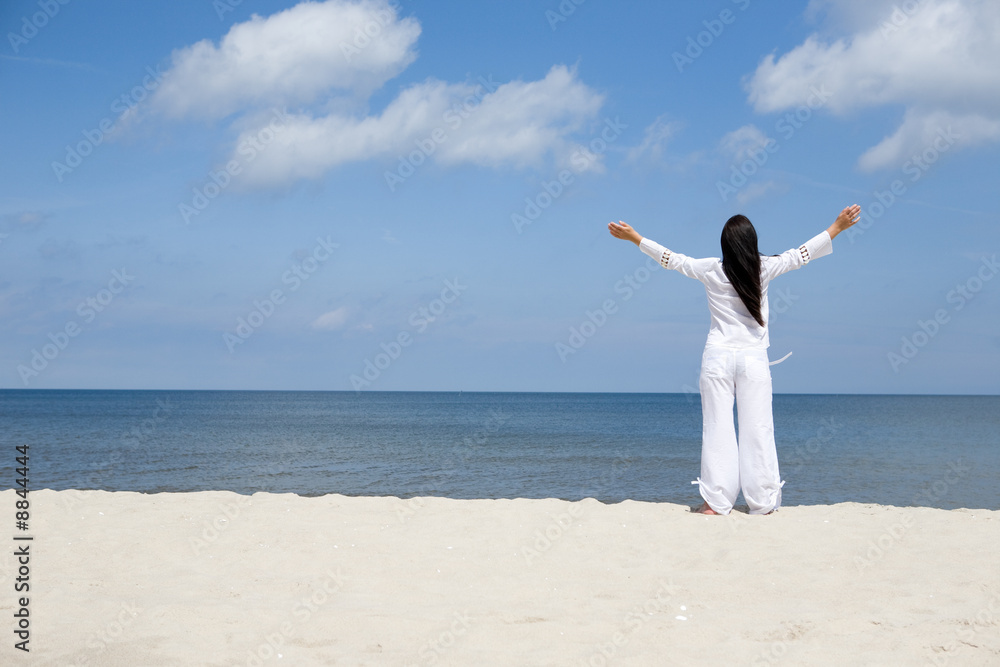 attractive brunette woman relaxing on the beach