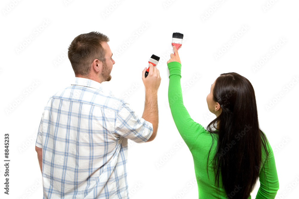 happy casual couple painting wall happy casual couple painting wall