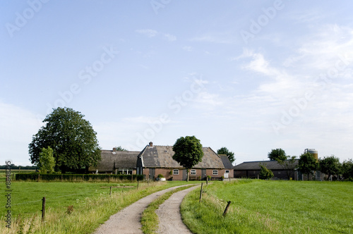 Landscape with farmhouse in the middle of the farmland © Ivonne Wierink