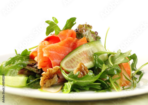 Salad with smoked salmon, walnuts, pears, cucumber and rocket.