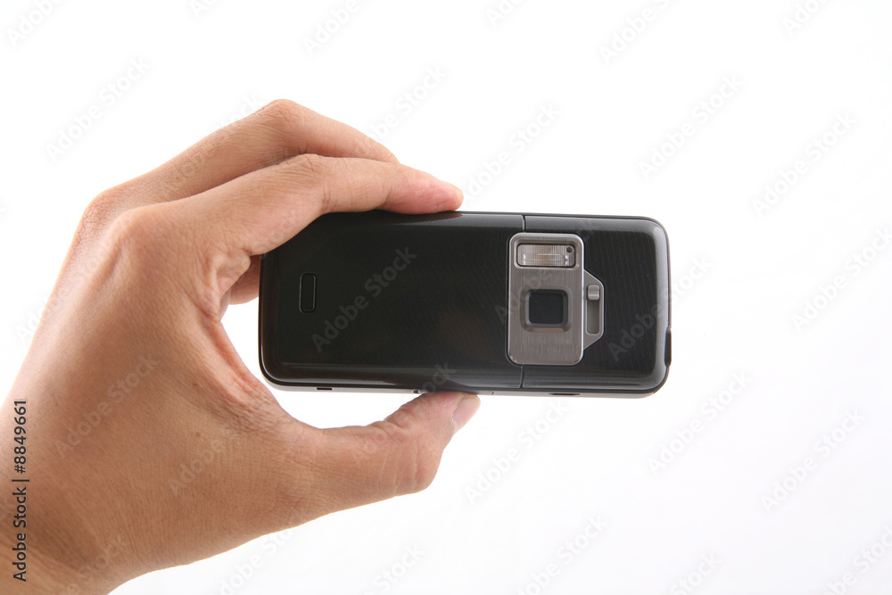 A man is holding a black cameraphone A man is holding a black cameraphone
