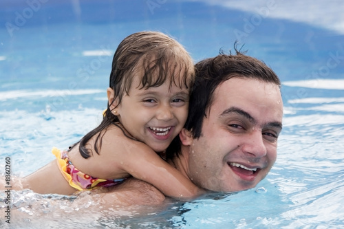 Father and daughter in a Swimming pool © Herjua
