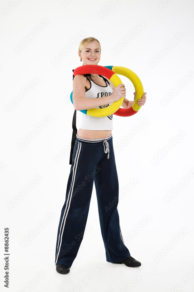 Young blonde woman with a flexible gym apparatus