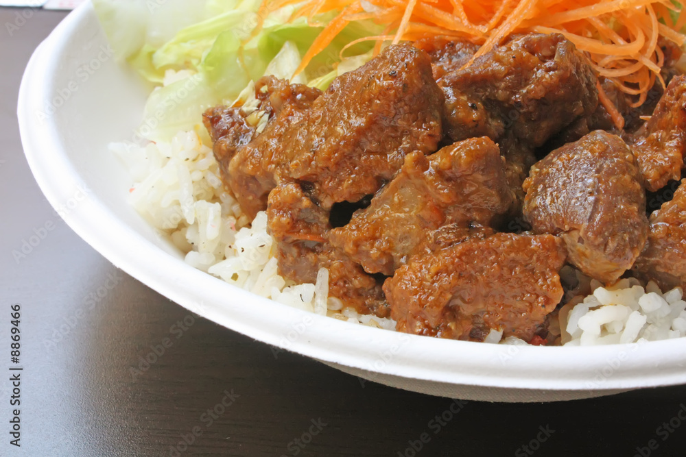 Beef Goulash Serving with Carrot and Lettuce on a Textured Table Beef Goulash Serving with Carrot and Lettuce on a Textured Table
