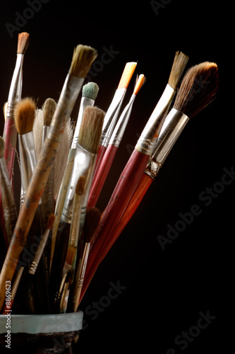 Art brushes well used in a jar on studio