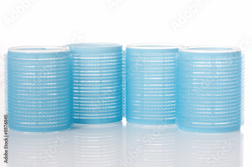 hair rollers in blue color on white background