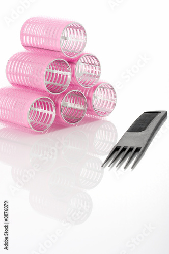 curlers and comb on a white background