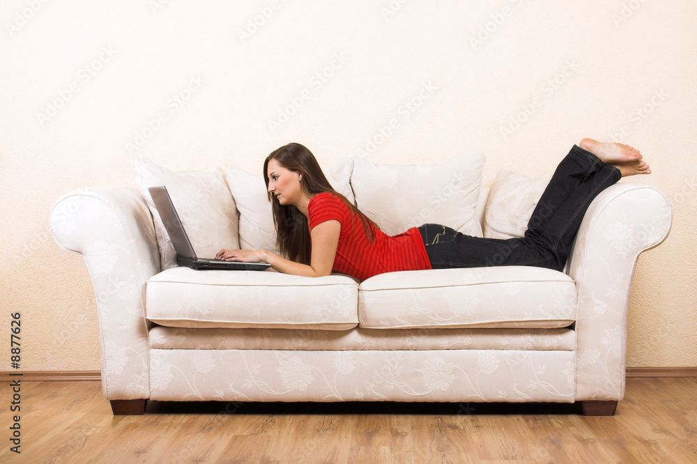 young woman on a lounge with laptop young woman on a lounge with laptop