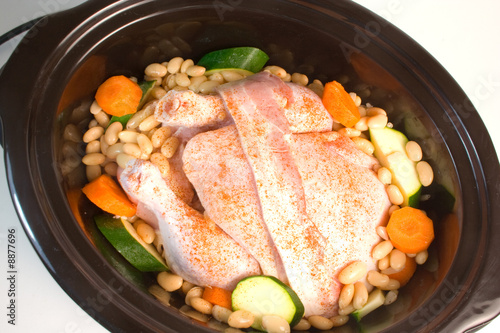 Fresh chicken prepared for cooking in a slow cooker. photo