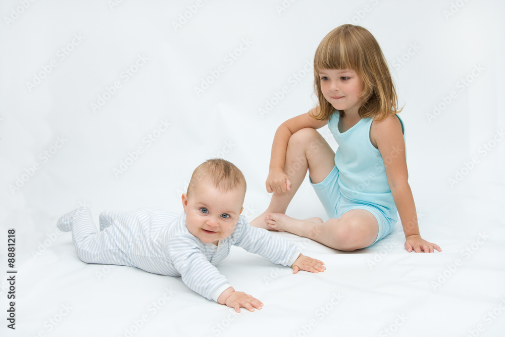 little brother and sister playing together, on white little brother and sister playing together, on white