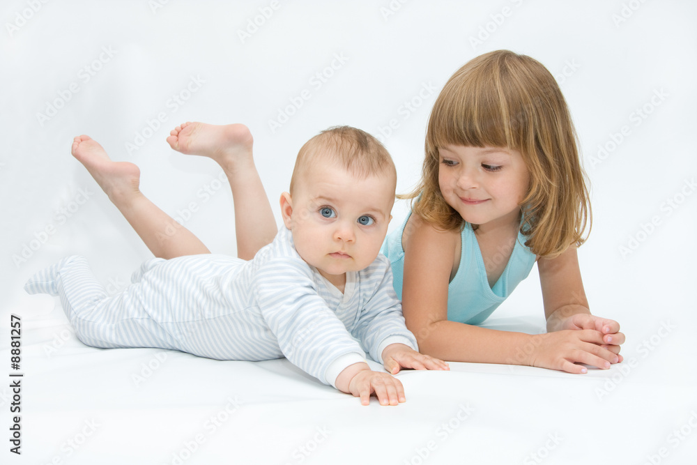 little brother and sister playing together, on white little brother and sister playing together, on white