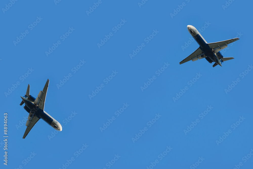 two flying planes isolated over blue sky two flying planes isolated over blue sky