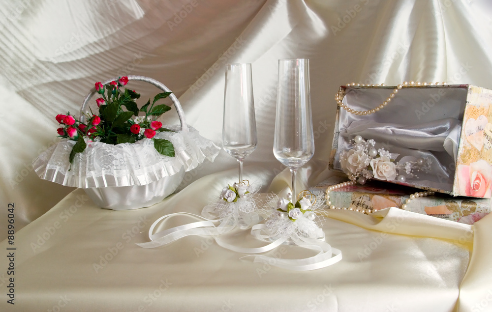 wedding still life is glasses and small basket with a bouquet