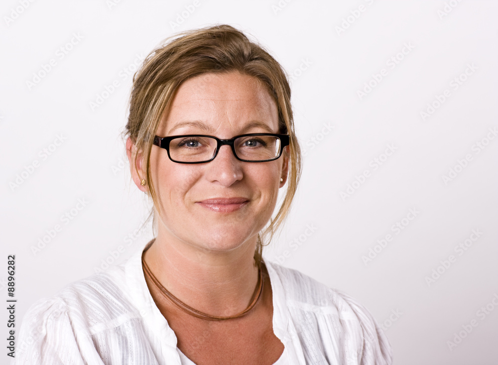 Beautiful woman looking into camera with a friendly smile Beautiful woman looking into camera with a friendly smile