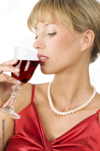 an elegant blond girl with necklace drinking red wine