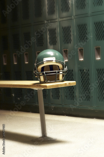 фотографія a football helmet on bench in locker room