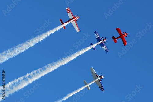 Stunt aircraft in formation, blue sky at air show performance