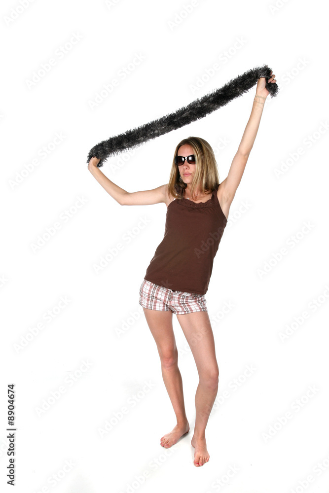 Naklejka premium teen in sunglasses lifting scarf over head