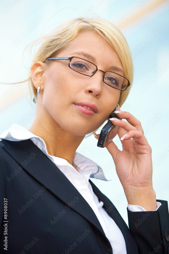 Young businesswoman looking at camera outside office Young businesswoman looking at camera outside office