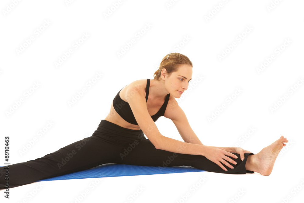 Fit young brunette pilates instructor showing exercises Fit young brunette pilates instructor showing exercises