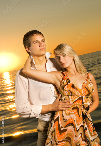 Young couple in love near the ocean at sunset © Nejron Photo