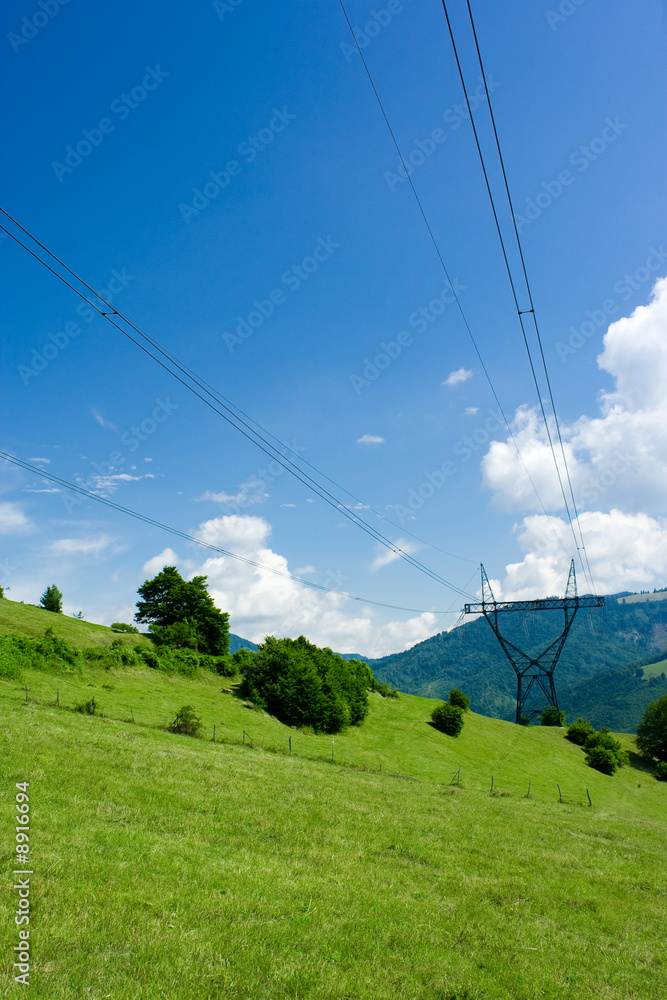 Power lines towers over blue sky