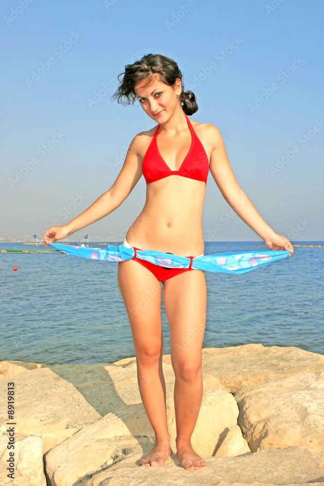 Pretty girl with pareo on the beach.