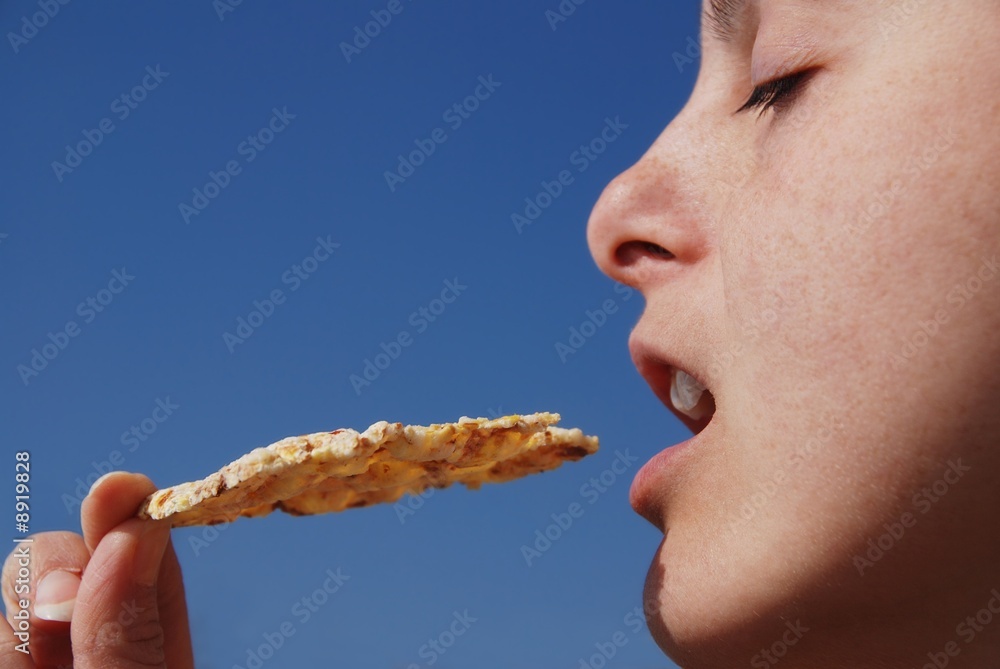 Young woman eats healthy squeezed popcorn meal