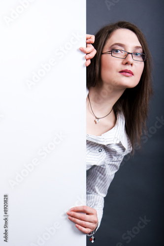 The woman holds the empty white poster