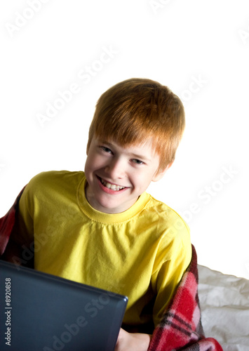 A smiling teenager with a laptop