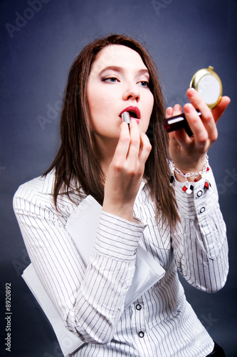The woman paints lips
