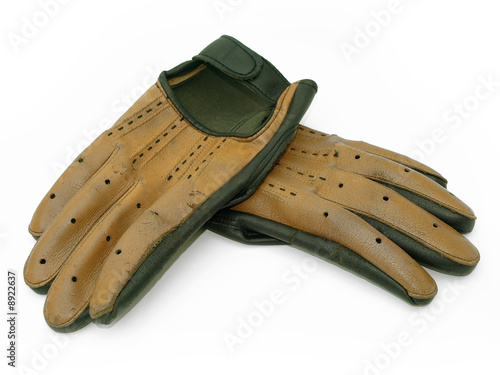 Pair of old driving gloves isolated against white background