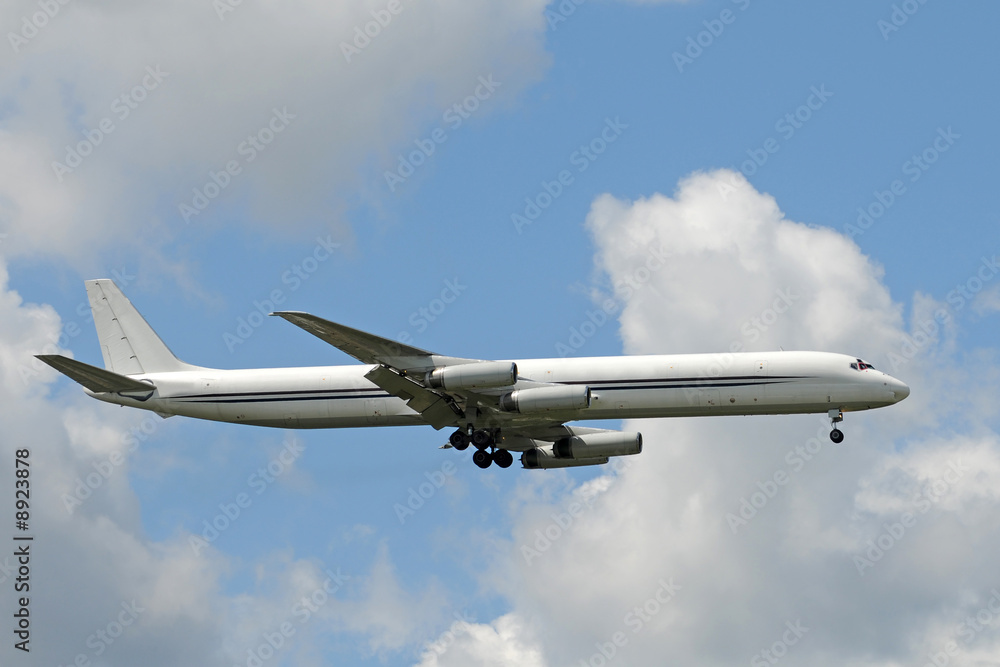 Fototapeta premium Unmarked cargo jet airplane landing side view