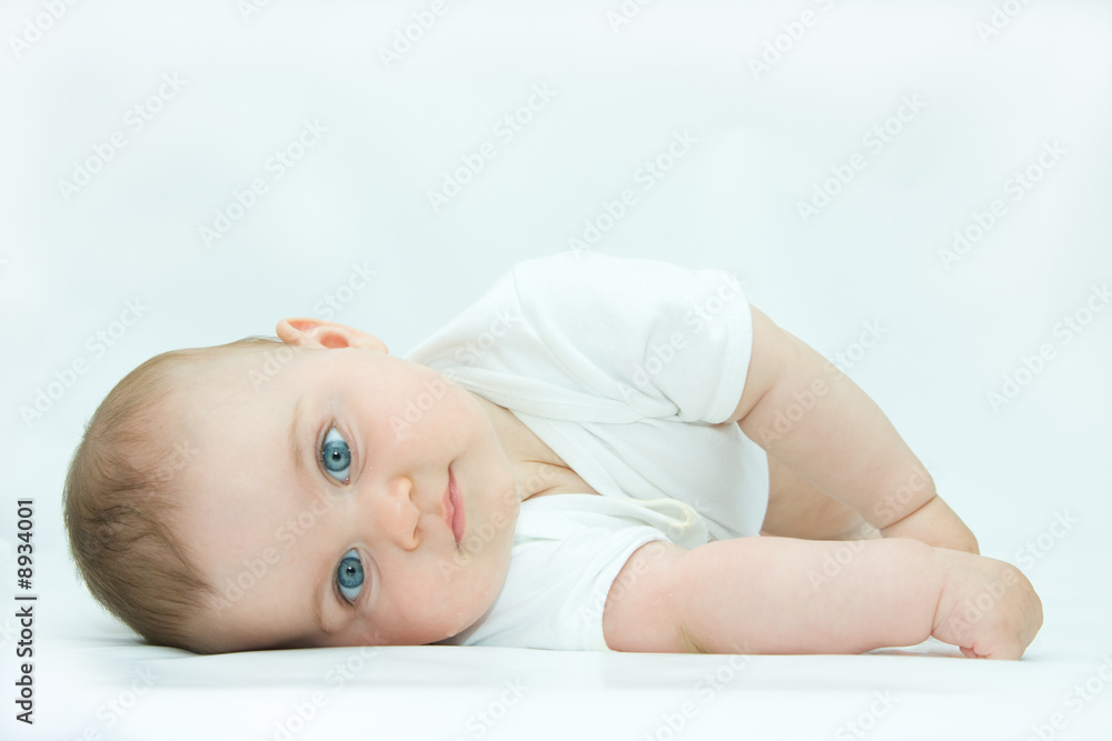 little, cute baby boy lying on white background little, cute baby boy lying on white background