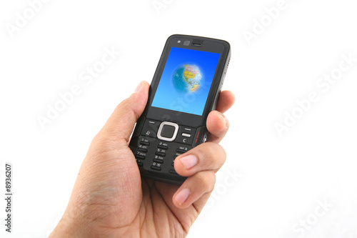 holding a mobile phone with a globe picture on screen