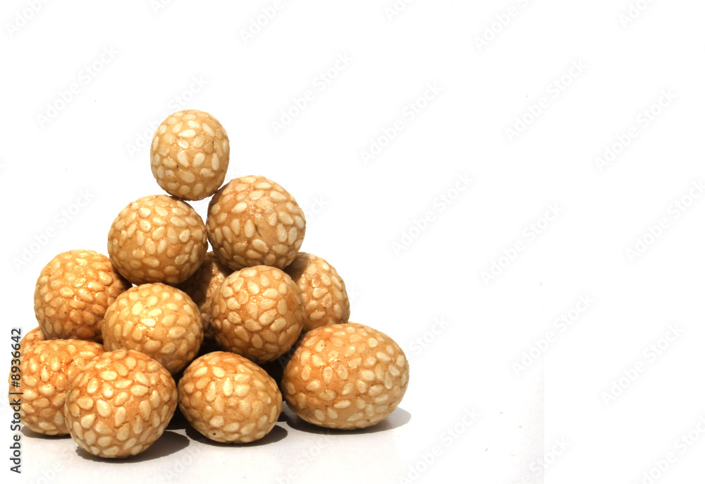 Bowl of Asian rice and sesame crackers against white background Bowl of Asian rice and sesame crackers against white background