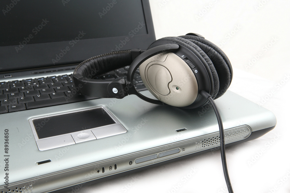 Shot of laptop with headphone isolated over white Shot of laptop with headphone isolated over white