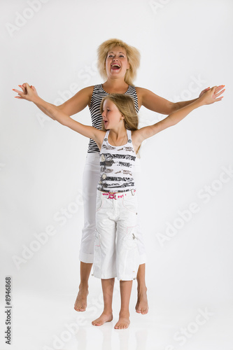 Fototapeta Naklejka Na Ścianę i Meble -  Young blonde woman and girl playing and laughing