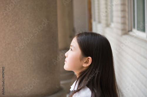 little asian girl looking at heaven