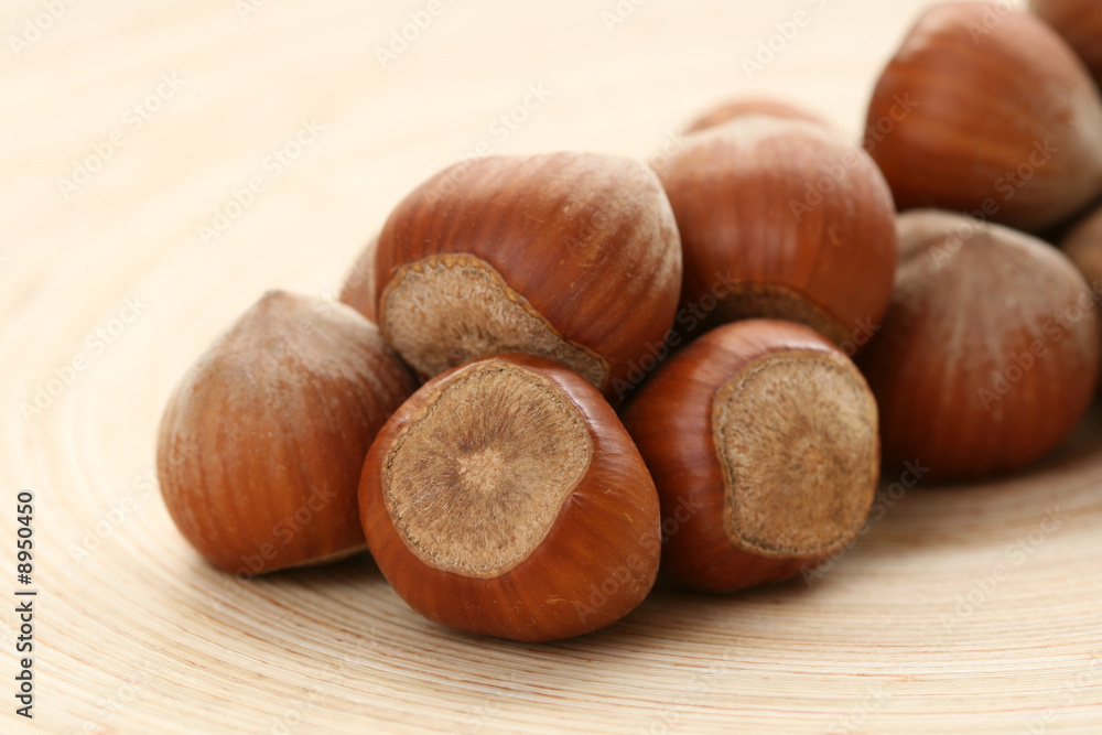 close-ups of hazelnuts on wooden table close-ups of hazelnuts on wooden table