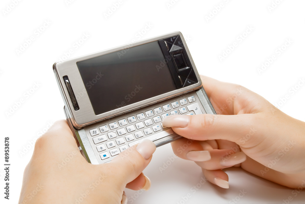 Female hand typing something on pda, isolated Female hand typing something on pda, isolated