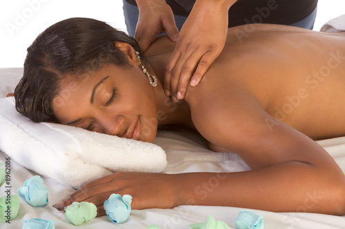 African-American woman getting massage in spa