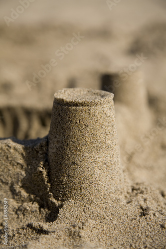 A sand castle at the beach made with inverted cups